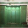 Гардеробна кімната з кутовими шафами зеленого кольору