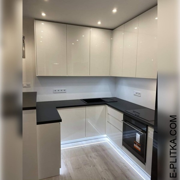 Біла глянсова кухня з барною стійкою та чорною стільницею